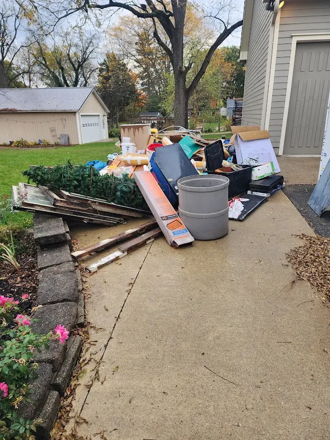 Dumpster being loaded with debris for Commercial Dumpster Rental in Menomonie